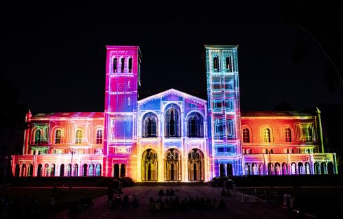 Royce Hall lit with multiple colors