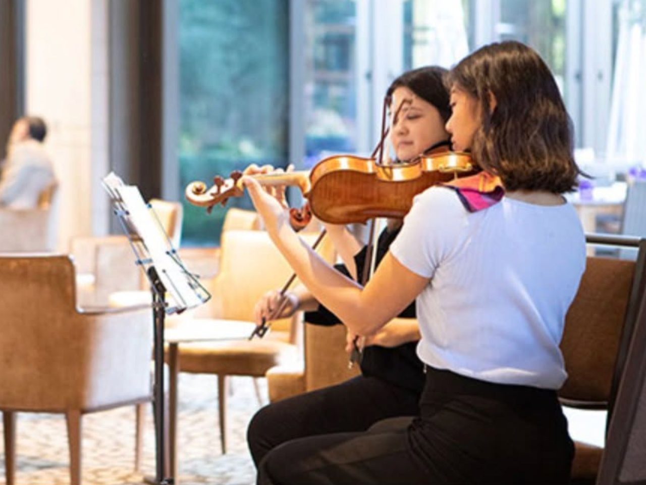 Violinists playing in the Luskin Conference Center lobby
