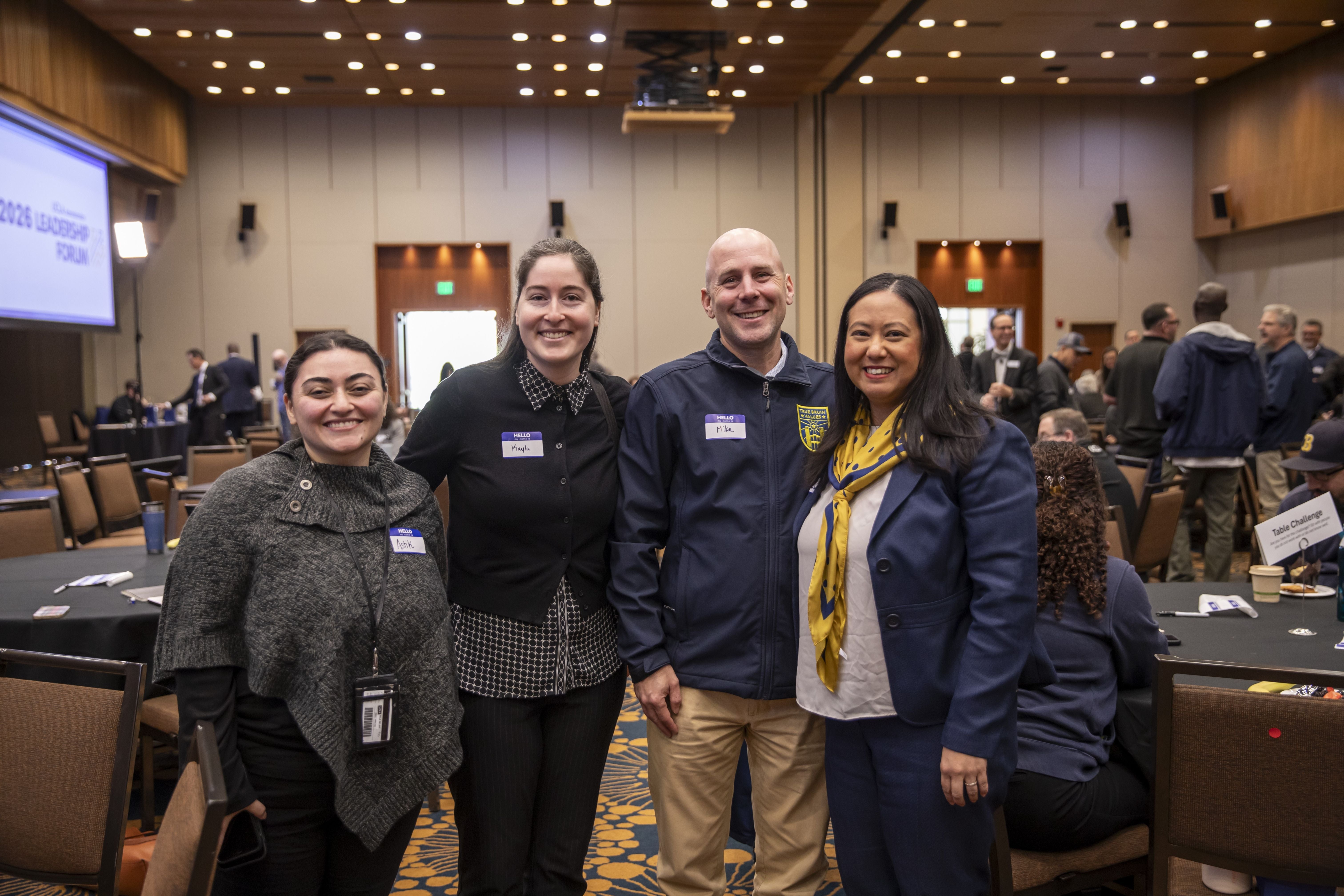 Group of four employees smiling at the camera