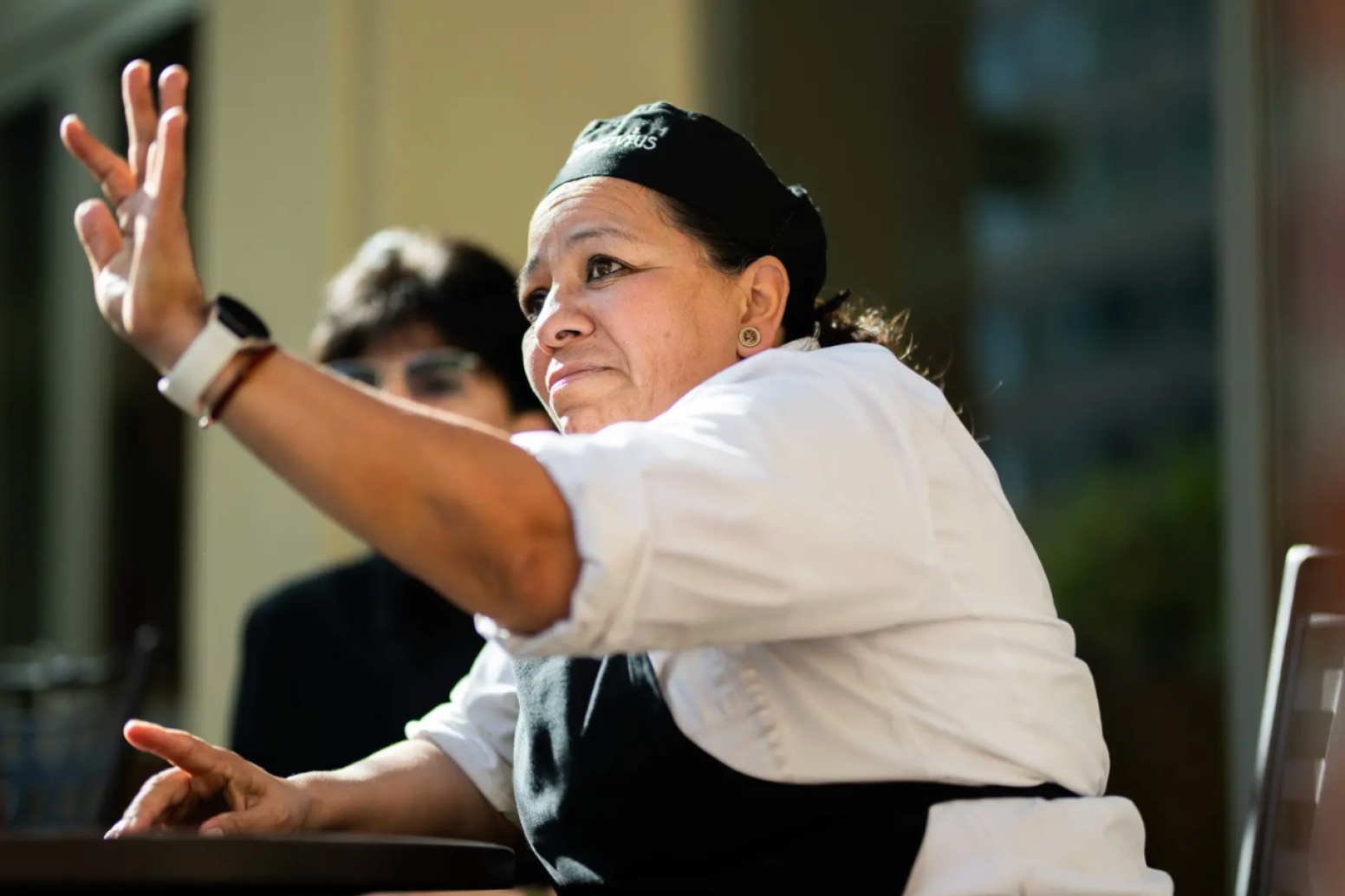 Employee raising her hand to interact in group discussion