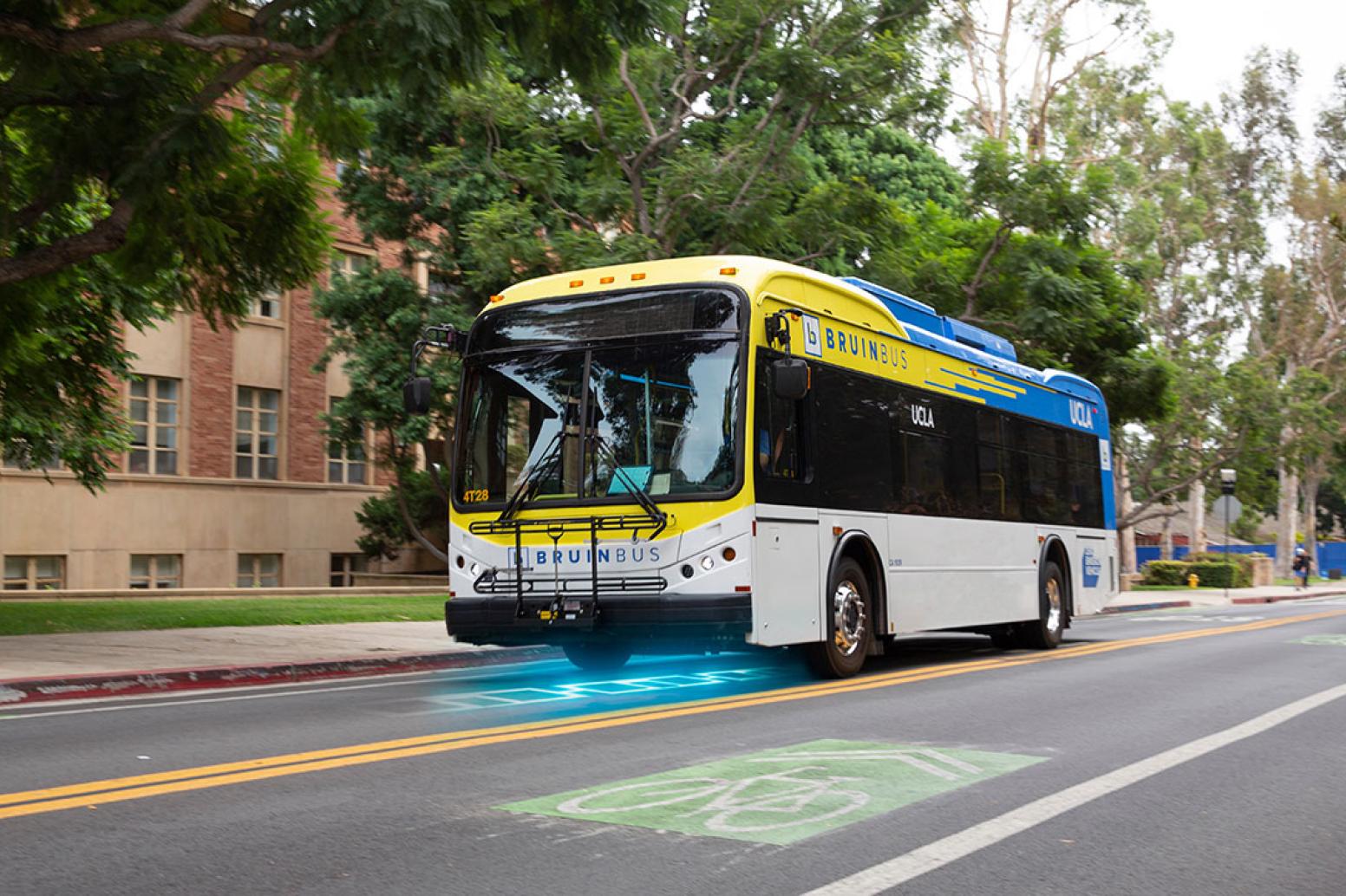 A bruin bus drives down an electrified road - modified image to show electricity coming up from the road to power the bus