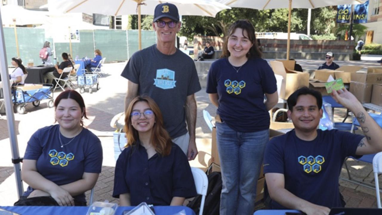 From left, Angelina Northcutt, Erin Valdecanas Matt Enright, Caroline Uhrig and Brian Campillo from Commuter and Parking Services working at the Sustainable Transportation Month Fair