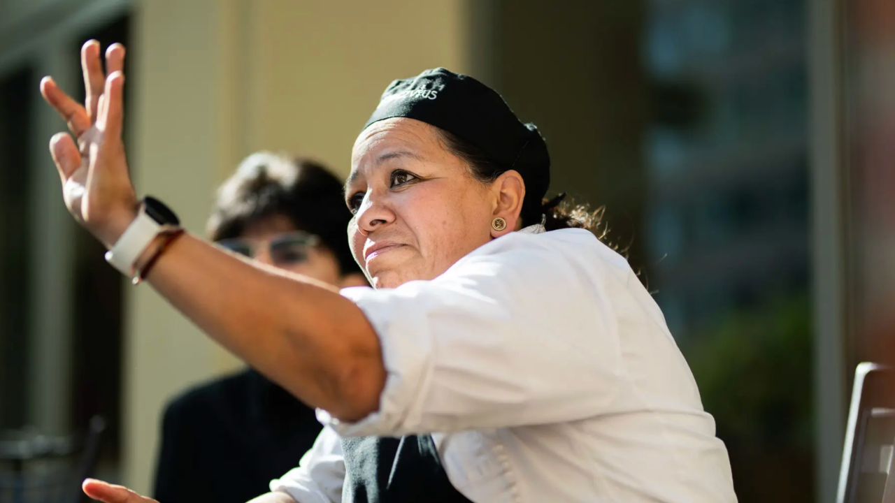 Employee raising her hand to interact in group discussion