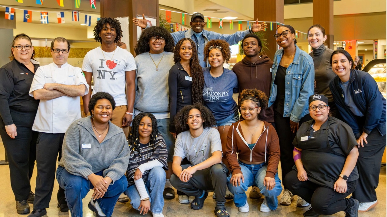 Group posing for the camera on campus