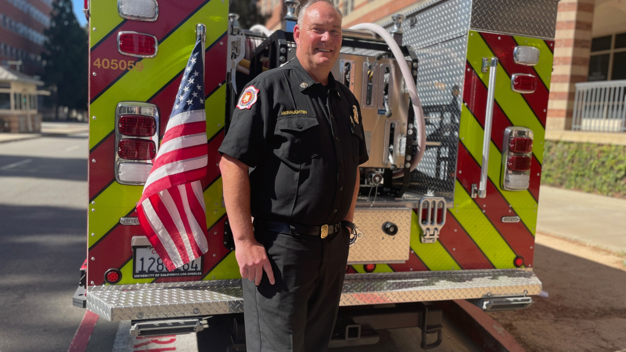 Steve McNaughten in front of a fire vehicle