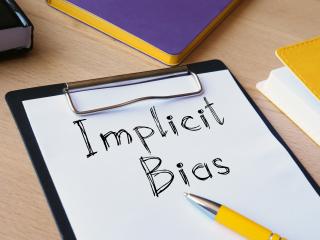 Clipboard with "Implicit Bias" written on it