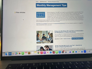 Monthly Management Tips site on a laptop