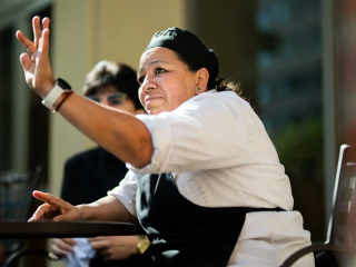 Employee raising her hand to interact in group discussion