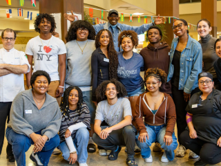 Group posing for the camera on campus