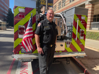 Steve McNaughten in front of a fire vehicle