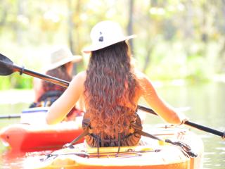 Women in kayaks paddling across the water